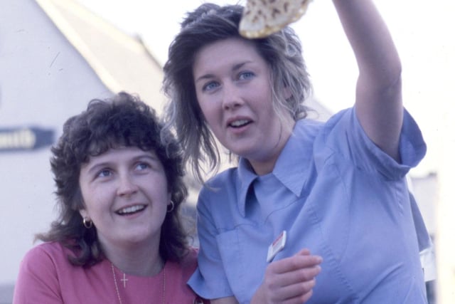 Susan Maughan (left) and Moira Baggott tosses a pancake as a warm up to the race across Elvet Bridge in Durham in 1988.