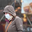 A file picture of a passerby in a mask as concerns are raised over the level of covid infection in the North East.