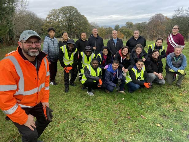 Daniel Krzyszczak, a member of the East Rangers with volunteers who have planted trees in Backhouse Park. Picture by FRANK REID'