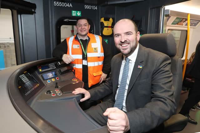 Transport Minister Richard Holden gets hands-on in the cab of the new train