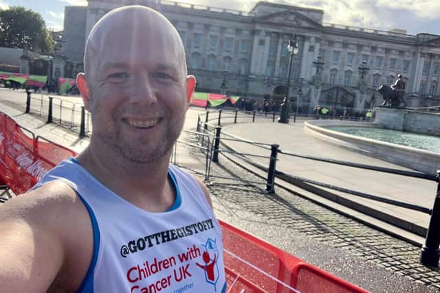 Chris in front of Buckingham Palace while taking part in the London Marathon.
