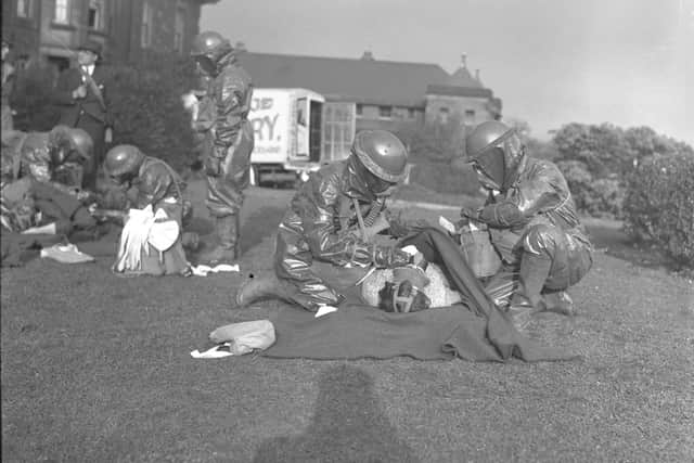 Rapid progress was being made in 1939 in training members of the Casualty Service in the town.  This Echo picture, taken in the grounds of a Sunderland hospital, shows two men in full protective clothing treating a patient.