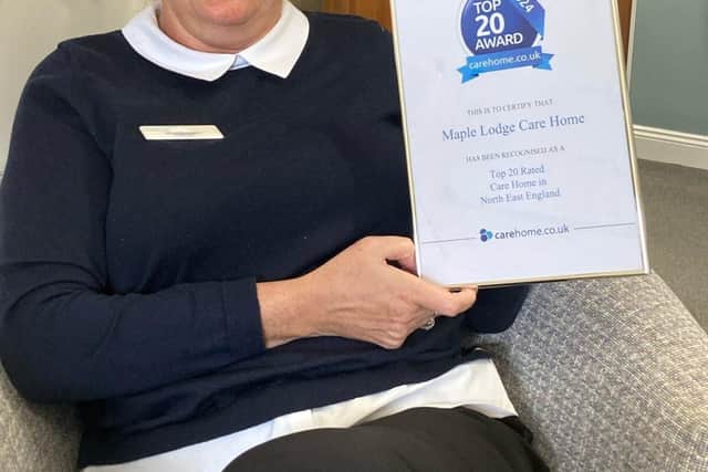 Home Manager Helen Taylor with the Top 20 Award certificate