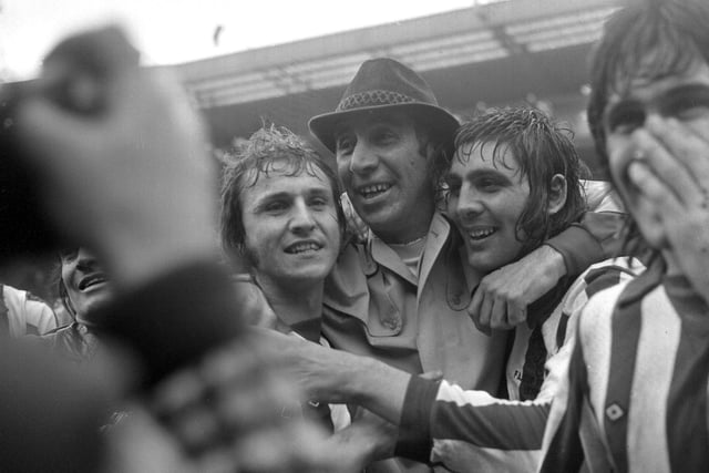 Sunderland manager Bob Stokoe is overcome by emotion as he hugs Dennis Tueart (left) and match winner Ian Porterfield, seconds after the final whistle.