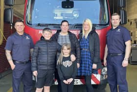 Olivia with mum Samantha, Auntie Kayley, brother Alfie, and TWFRS firefighters.