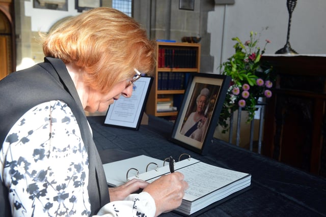 Church warden Ann Craig writing a tribute at Sunderland Minster.