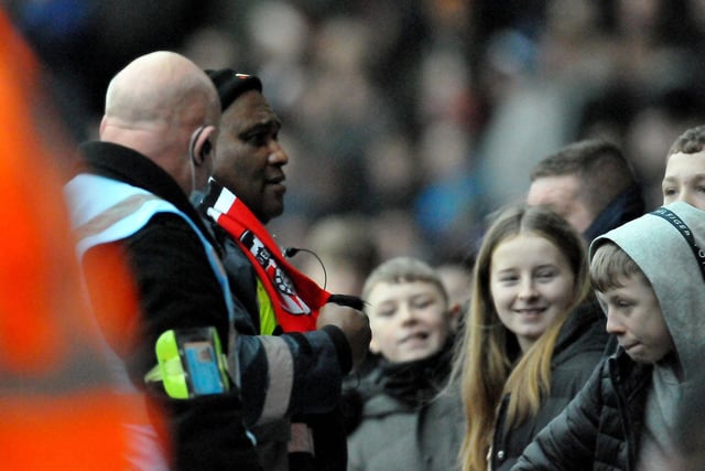 A Doncaster Roverssteward wears a Sunderland scarf as the Black Cats win away from him