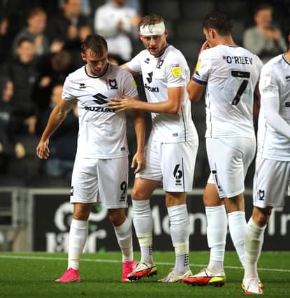 MILTON KEYNES, ENGLAND - SEPTEMBER 28: Scott Twine of Milton Keynes Dons is congratulated by team mate Harry Darling after scoring his and his sides first goal during the Sky Bet League One match between Milton Keynes Dons and Fleetwood Town at Stadium mk on September 28, 2021 in Milton Keynes, England. (Photo by Pete Norton/Getty Images