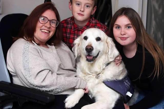 Tara Johnson pictured in 2019 with her children Jack and Molly and her dog Butler from the Canine Partners charity.