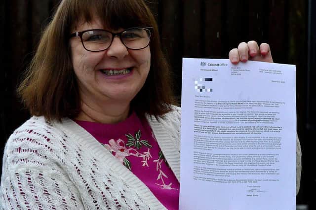 Kim Sheers with her British Empire Medal letter. Picture by Frank Reid