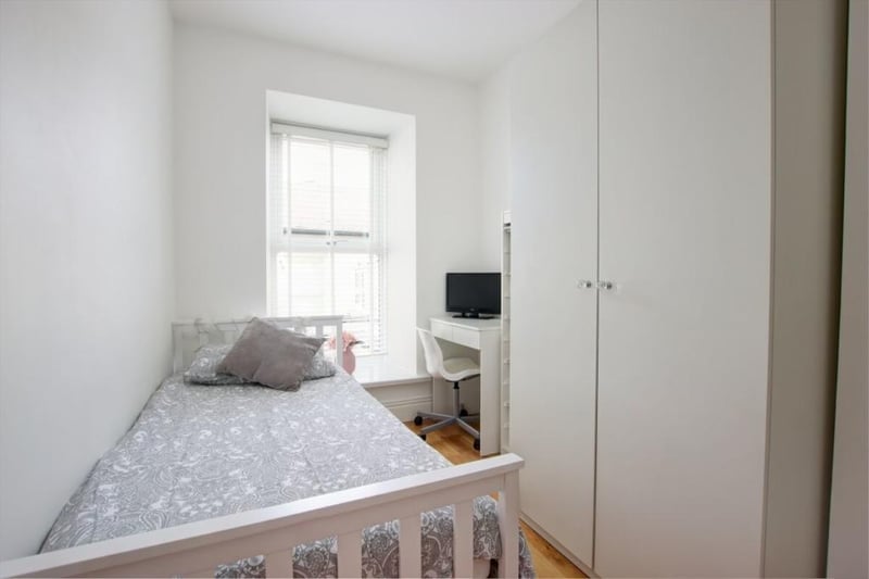 This is one of four bedrooms inside the home, which is described as a "beautiful residence with period features, impressive stone portico entrance and sash windows."