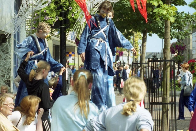 Stilt walkers mix with the public in Sunderland city centre in August 2000. Are you pictured?