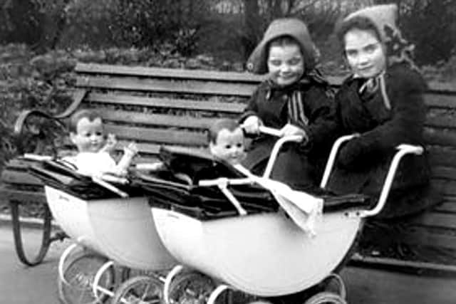 Maureen and Margaret playing with their prams.
