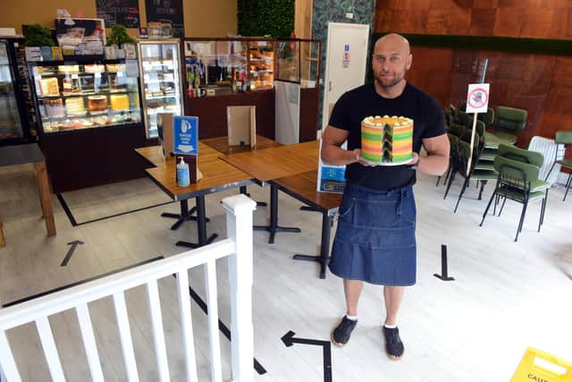 Ariel Niesporek, of Pati Cake Patisserie, stands next to the arrowed one-way system inside his family's Sunderland cake and coffee shop.