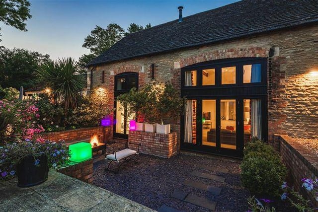 This Grade II listed property is a stone built barn conversion, and boasts five bedrooms, three of which are en suites. Features of the house include an open plan kitchen and dining room, two formal reception rooms and even a wood burning stove found outside. Guide price of £950,000.