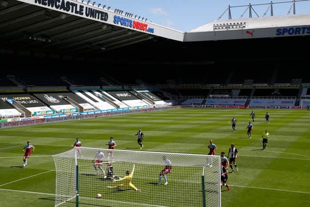 General view inside the empty stadium as Miguel Almiron of Newcastle United scores his team's second goal past Lukasz Fabianski of West Ham United during the Premier League match between Newcastle United and West Ham United at St. James Park on July 05, 2020 in Newcastle upon Tyne, England.