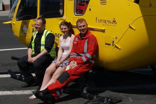 Alice Roberts in 2011 being reunited with the North West Air Ambulance pilot and one of the paramedics who saved her life.