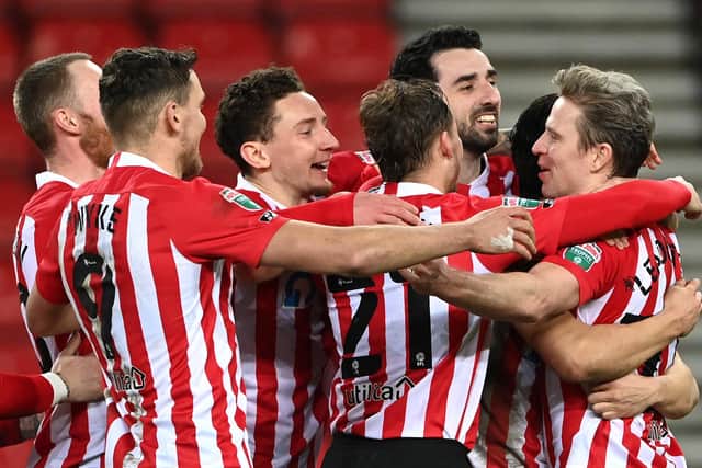 Sunderland players congratulate Grant Leadbitter of Sunderland after he scores the winning penalty during the Papa John's Trophy semi-final match between Sunderland and Lincoln City on February 17, 2021.