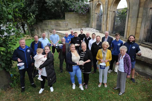 Creating the first stones for the new memorial garden at the Sunderland Fans Museum, Karen and Megan Matthews, Carol and Quinn King, and Dorothy Stewart with team members, sponsors and Museum founder Michael Ganley (left)