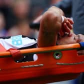 Joelinton of Newcastle United is stretchered off.