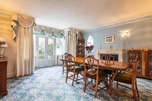 The large dining room has a bay window and French doors which overlook the extensive garden.