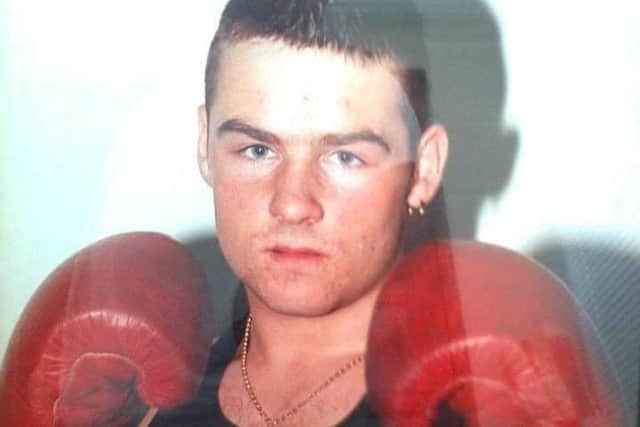 Michael became a national boxing champion twice in his early career - with the photo hanging proudly in the gym.