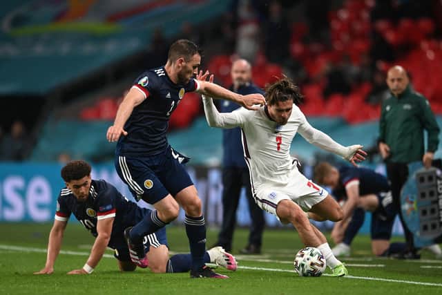 Jack Grealish of England runs with the ball whilst under pressure from Stephen O'Donnell and Che Adams of Scotland during the UEFA Euro 2020 Championship Group D match between England and Scotland at Wembley Stadium on June 18, 2021 in London, England. (Photo by Andy Rain - Pool/Getty Images)