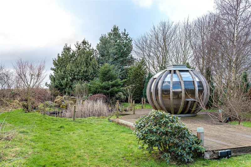 The outdoor grounds also include a working vegetable garden, orchard, mature pond, play area and a garden pod.