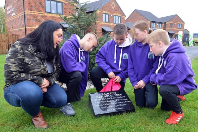 Gemma Lowery unveils the Bradley Memorial Tree with children from Blackhall Primary School at Hardwicke Place, Blackhall.