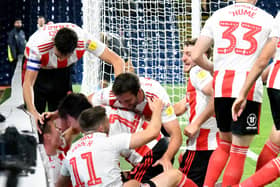 The Sunderland players celebrate a goal earlier in the season.