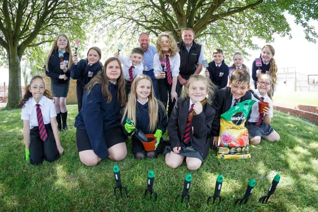 Children from the school's eco-club with some of the gardening equipment donated by Esh Construction.