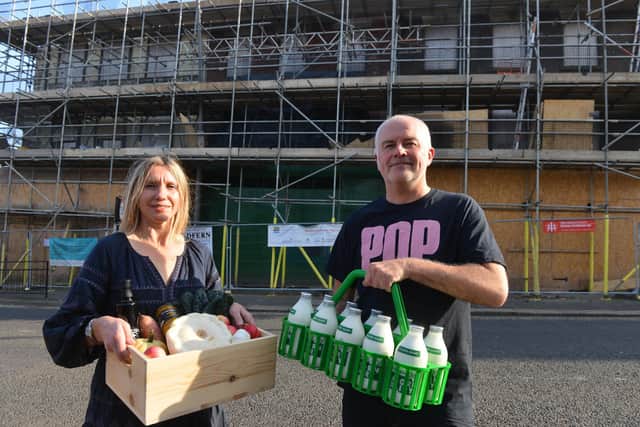 Sunshine Co-operative owners Claire Wayman and Wojtek Bozik with locally produced milk and organic fruit and veg box outside Pop Recs development