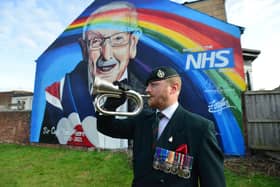 Bugler Scot Barrs plays the Last Post at the unveiling of the Sir Tom Moore mural Picture by FRANK REID