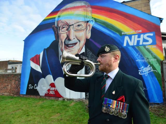 Bugler Scot Barrs plays the Last Post at the unveiling of the Sir Tom Moore mural Picture by FRANK REID