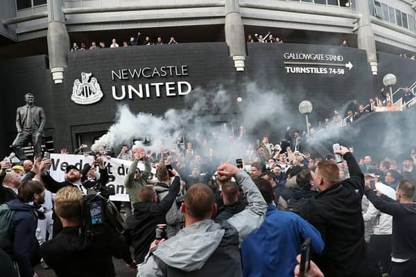Newcastle United supporters celebrate last year's takeover.