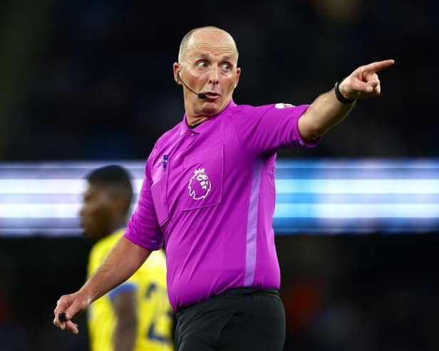 Referee Mike Dean looks on during the Premier League match between Manchester City and Brighton & Hove Albion at Etihad Stadium on April 20, 2022 in Manchester, England. (Photo by Clive Brunskill/Getty Images)