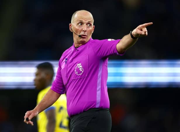 Referee Mike Dean looks on during the Premier League match between Manchester City and Brighton & Hove Albion at Etihad Stadium on April 20, 2022 in Manchester, England. (Photo by Clive Brunskill/Getty Images)