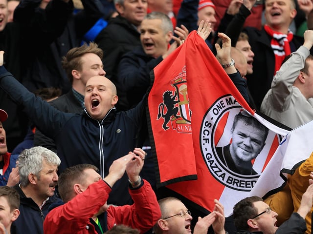 Sunderland fans celebrate after the Premier League match between Norwich City and Sunderland at Carrow Road on April 16, 2016.
