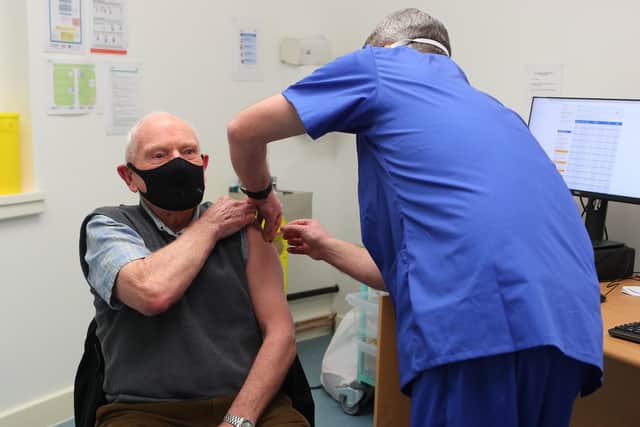 Pharmacist Andrew Hudson administers a dose of the coronavirus vaccine to Robert Salt, 82, at Andrews Pharmacy, in Macclesfield, Cheshire. which is one of six pharmacies nationwide to have started offering Covid-19 vaccinations.