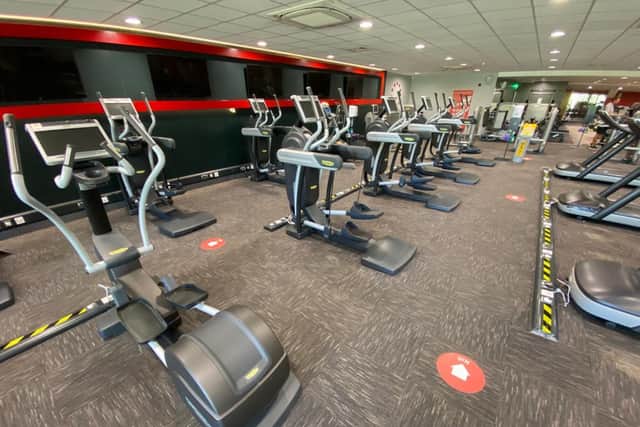 Inside the modified gym machines are separated by a two metre distance and floor markings show the one way system.