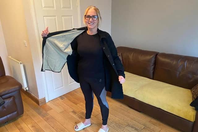 Donna with one of the shirts she used to wear before she lost her weight.