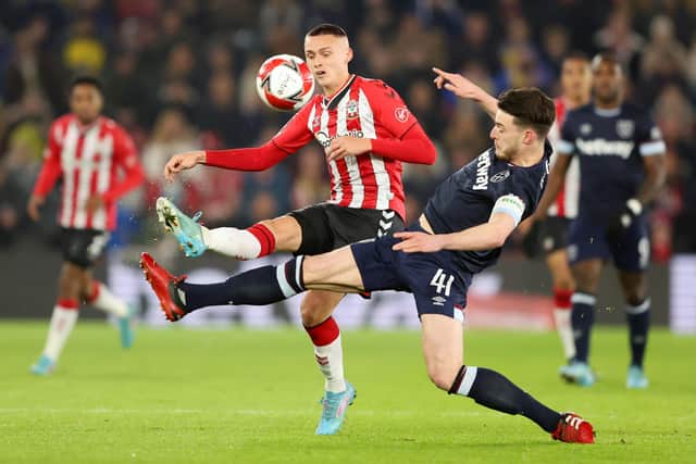 SOUTHAMPTON, ENGLAND - MARCH 02: Declan Rice of West Ham United battles for possession with Will Smallbone of Southampton during the Emirates FA Cup Fifth Round match between Southampton and West Ham United at St Mary's Stadium on March 02, 2022 in Southampton, England. (Photo by Warren Little/Getty Images)
