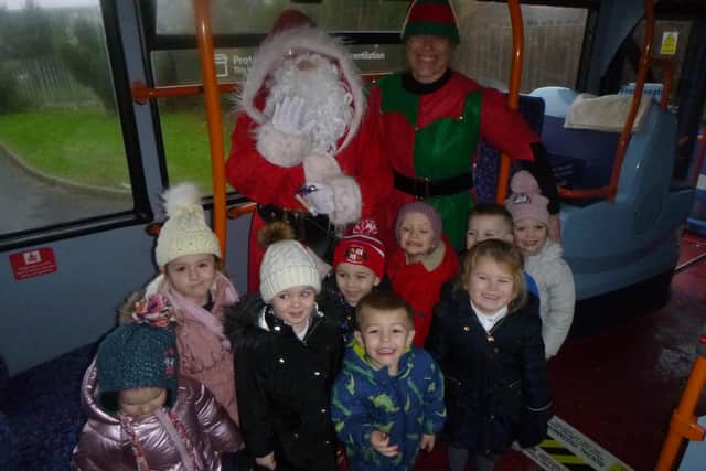 Children from Pennywell Early Years Centre aboard the festive Stagecoach bus with Santa and Big Elf.