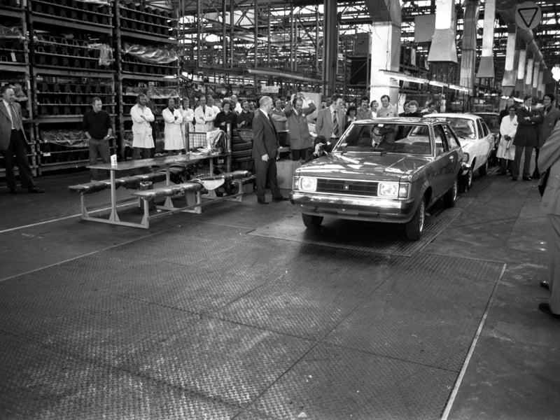 A worker raises his hands in horror when Bruce Millan, Secretary of State for Scotland, chooses reverse gear when he drives the new Chrysler Sunbeam off the production line at the Linwood car plant in September 1977.