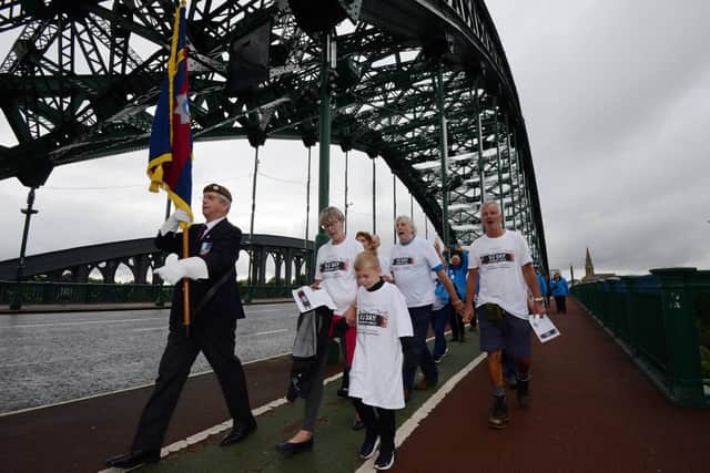 Walkers pass over the Wearmouth Bridge.
