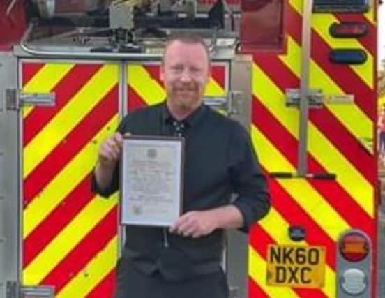 Tony Chapman with his certificate marking his retirement.  Photo used with courtesy of Tyne and Wear Fire and Rescue Service.