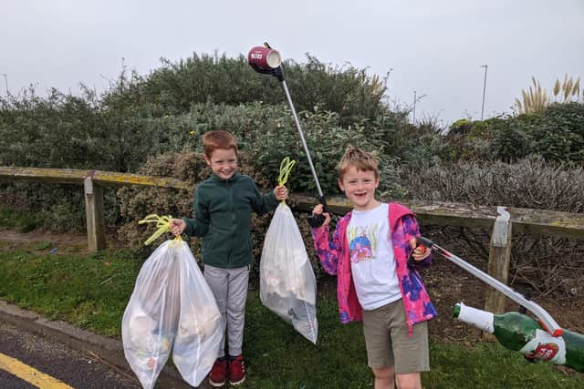 Andrew Saville and his brother Matthew collecting rubbish in the local area.