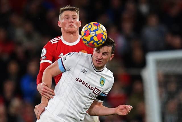 Manchester United's Scottish midfielder Scott McTominay (L) vies with Burnley's New Zealand striker Chris Wood (R) during the English Premier League football match between Manchester United and Burnley at Old Trafford in Manchester, north-west England, on December 30, 2021 (Photo by OLI SCARFF/AFP via Getty Images)