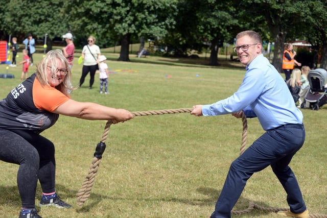 Weights and Cakes workshop coach Zoe Chandler with Cllr Michael Butler taking part in the tug-of-war.