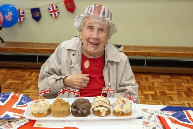 Marjorie Curry, 92, looks to decide which Coronation cake to enjoy first.